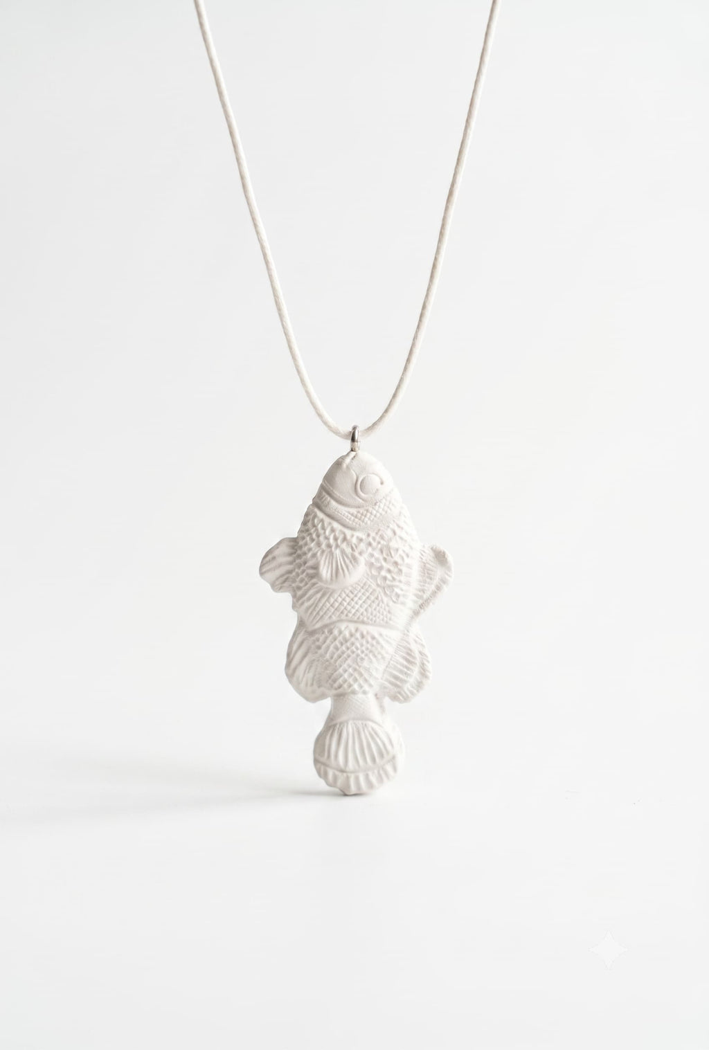 White fish pendant