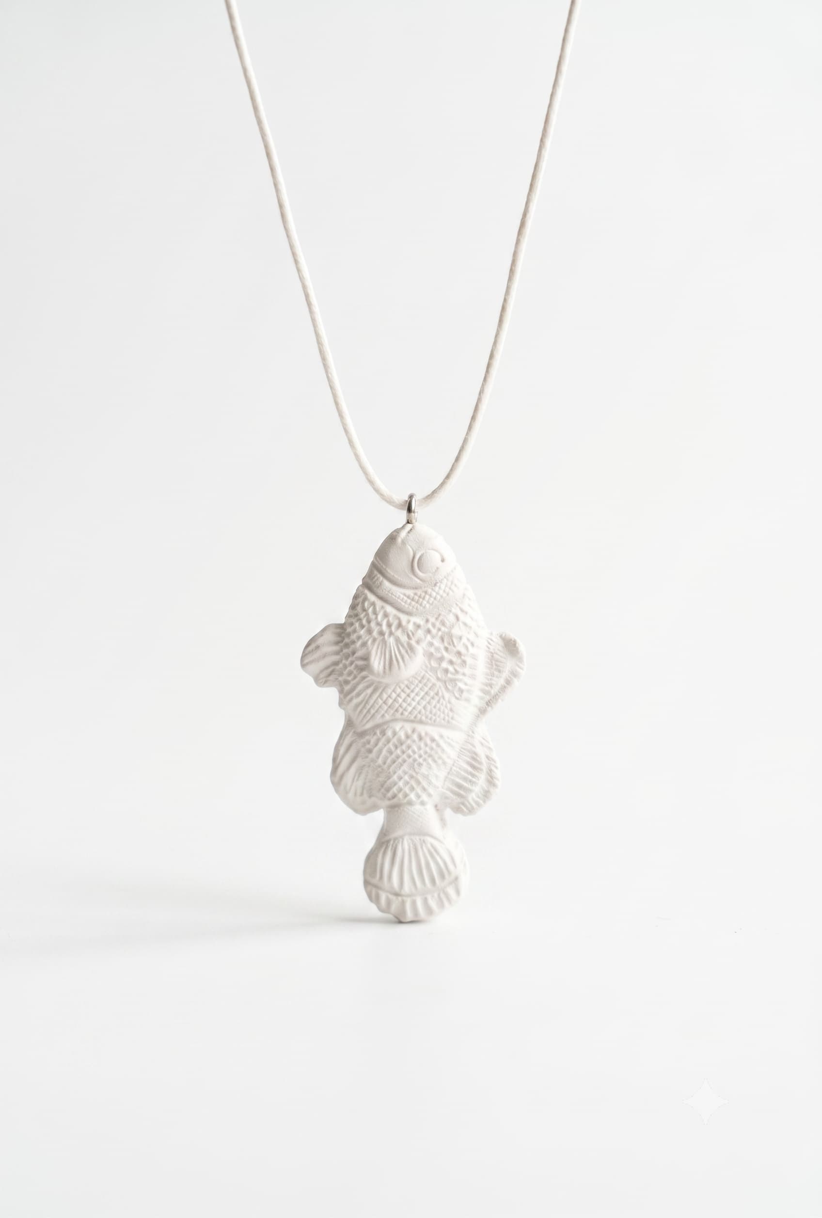 White fish pendant