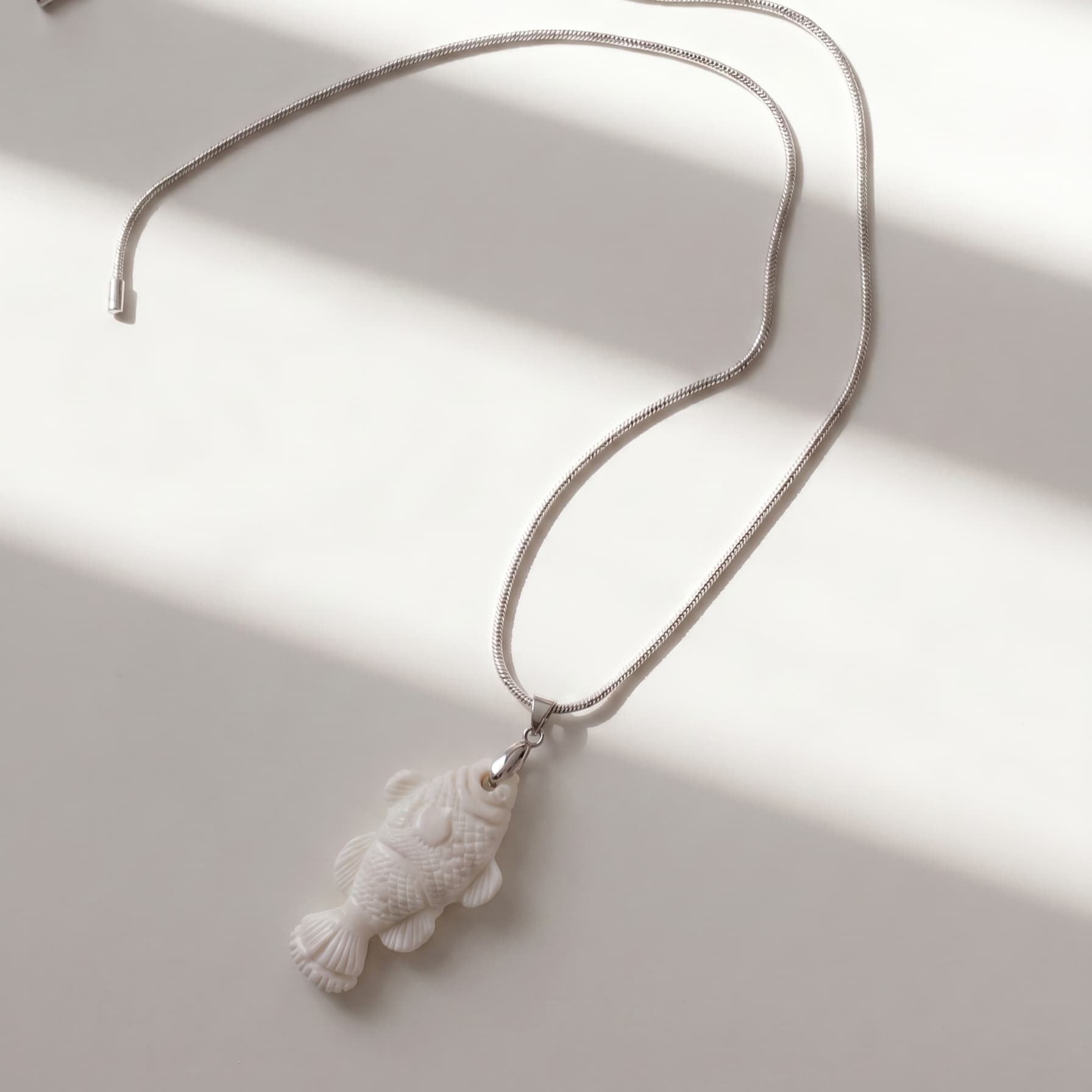 White fish pendant