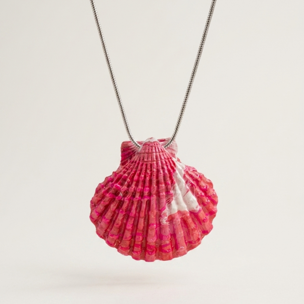 Shell-shaped pendant on a chain against a white background