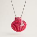 Shell-shaped pendant on a chain against a white background